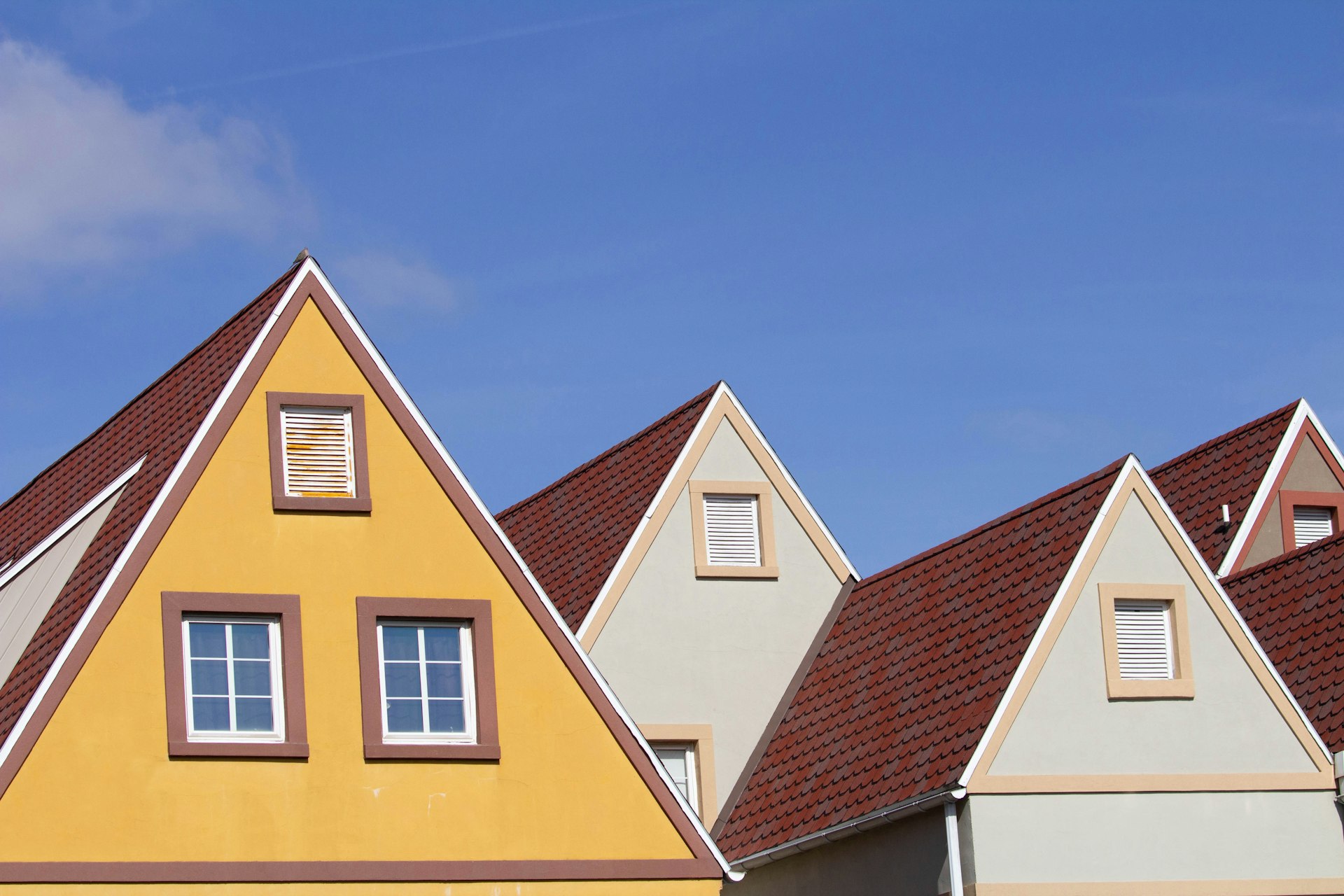 a row of beautiful roofs with a blue sky in the background